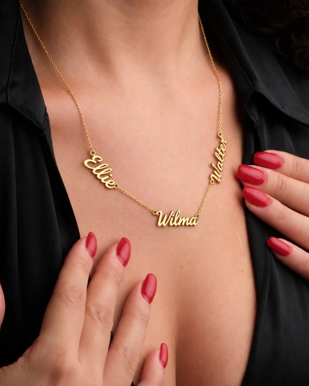 Woman wearing a gold necklace with the names Ellie, Wilma and Walter